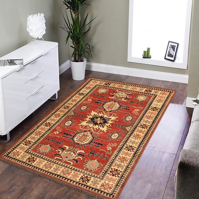 Enhance your home with this exquisite hand-knotted Super Kazak rug, crafted from fine hand-spun wool and dyed with all-...