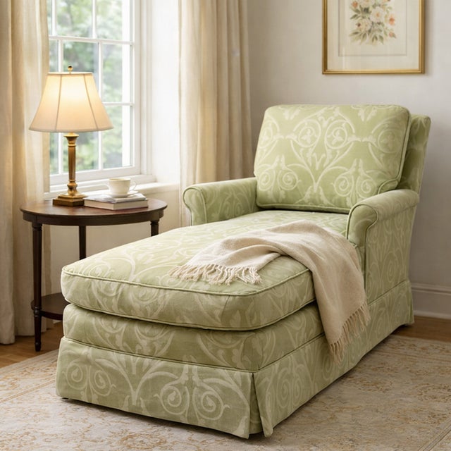 A very comfortable custom upholstered chaise lounge featuring classic rolled arms and a tailored skirted base. The...