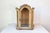A petite Venetian 18th century period Rococo painted wood vitrine with carved crest and glass door. Created in Italy...