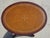 Small side table in solid mahogany with a lovely oval top covered in brown leather with touches of gold. The leather is...