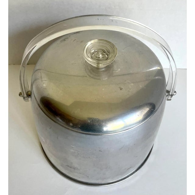 Here is a wonderful piece that is from the mid-century in the Atomic/Space Age design! The ice bucket is made from a...