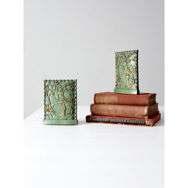 A pair of vintage Syroco bookends featuring a raised Chinoiserie landscape with pagoda, arched bridge, and flowering tree....