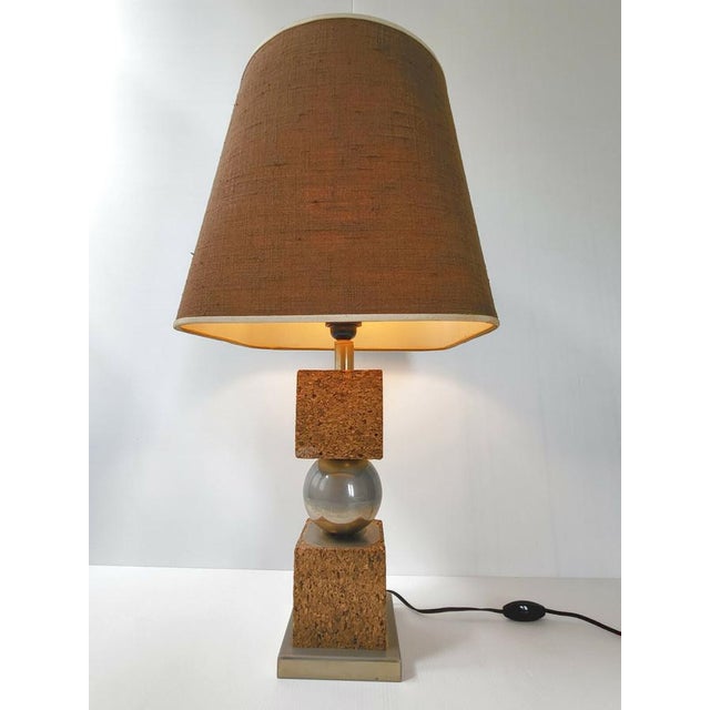 Good overall condition, but the gold plating on both the globe and the base has faded. Lampshade in good condition. Works....