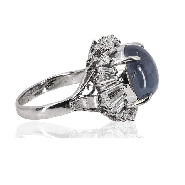 Platinum ring with one 8.76 carats blue star sapphire and 1.42 carats of round and baguette cut diamonds. 10.64 grams Size...