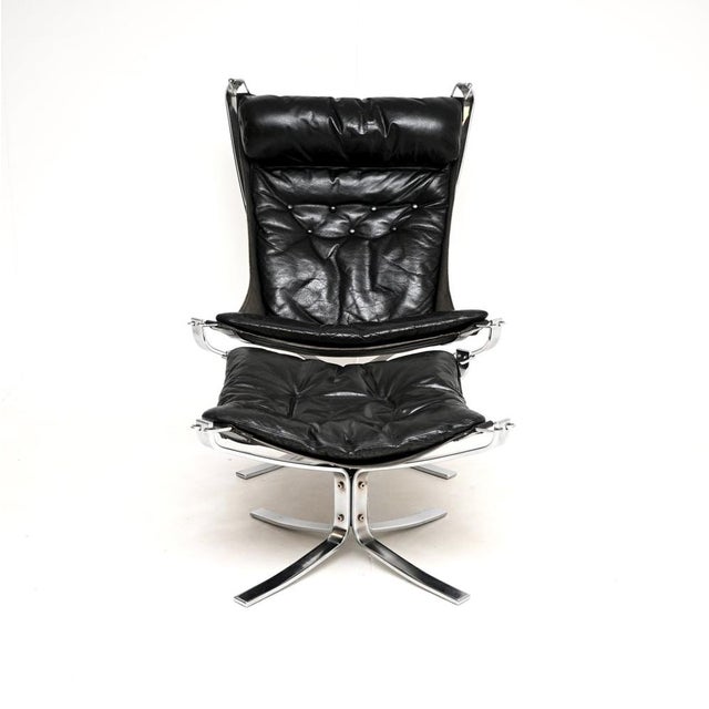 A stylish and iconic vintage chrome and leather falcon chair with stool by Sigurd Ressel. It was made in Norway by Vatne...