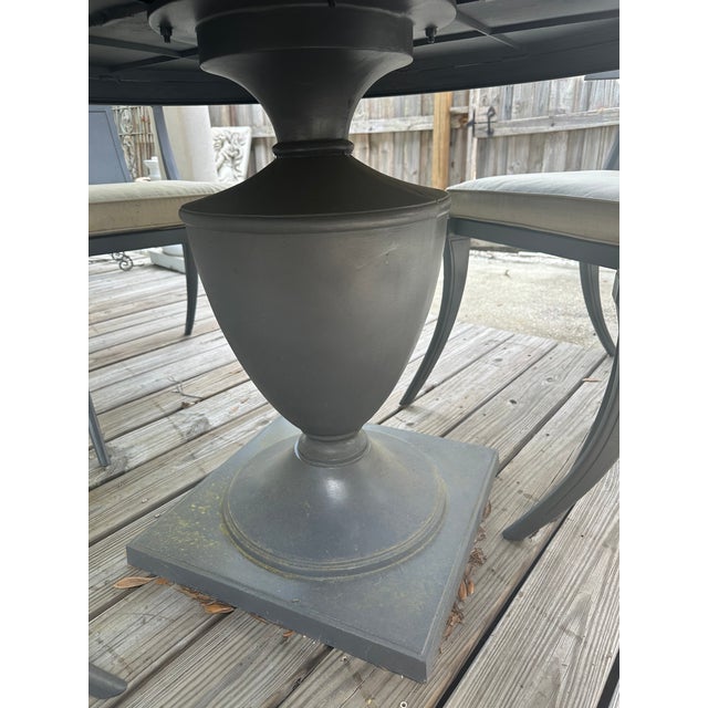 Classic 48” round pedestal table with 4 cushioned Klismos chairs. Dark gray finish. Cushions are covered in a tan linen...