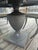 Classic 48” round pedestal table with 4 cushioned Klismos chairs. Dark gray finish. Cushions are covered in a tan linen...