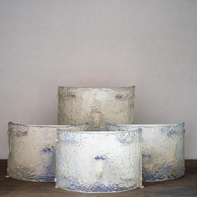 Four mazzega wall sconces from the 1970s. italian design. Murano. iridescent glass in white and transparent tones. model...