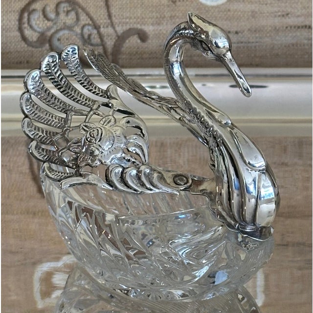Faberge inspired crystal swan with graceful sterling wings. Crystal body has deep cuts around as well as a striking...