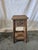 A beautifully handcrafted reclaimed teak side table featuring authentic weathered wood surfaces, dramatic grain texture,...