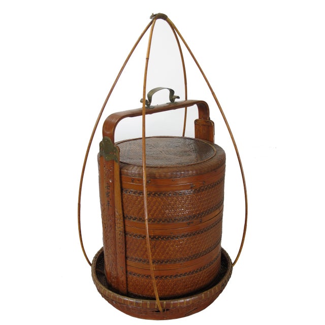 This bamboo basket was used as a container with 3 separate compartments to transfer the food by the owner. The owner's...