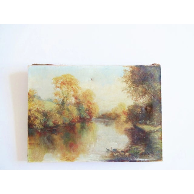 An antique French oil painting of a landscape featuring a river lines with trees and a duck and her ducklings swimming in...
