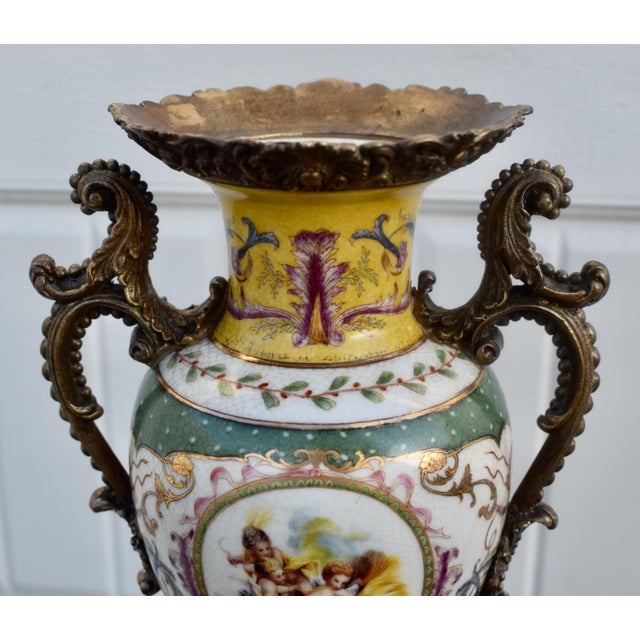 Vintage (1980's) Vase/Urn has a French Sevres Style. Made of Porcelain with Bronze Ormolu. Painted Multi-Colored Cherub...
