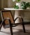 This pair of sculptural vintage lounge chair are characterized by its prominent, elegantly curved wooden arms and a hand-...