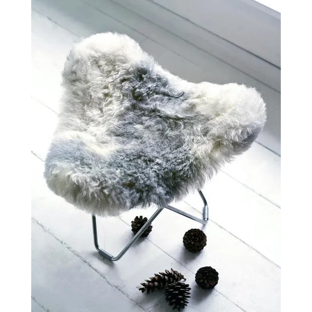Iceland Flying Goose Footstool by Cuero Design Dimensions: D 48 x W 47 x H 48 cm. Materials: Sheepskin and metal. Finish:...