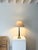 A solid brass vintage table lamp with a classical column form and a timeworn patinated finish. The squared stem sits on a...