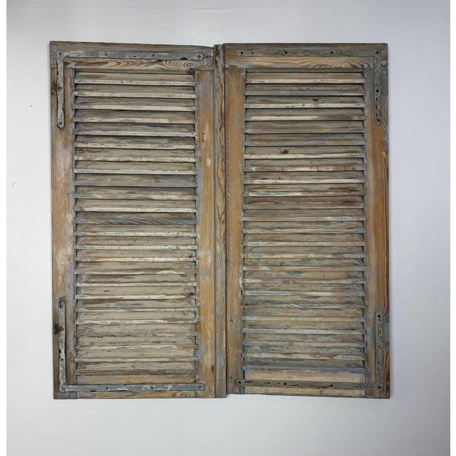 These 19th-century antique French shutters showcase a classic provincial style with a rich, weathered patina that speaks...