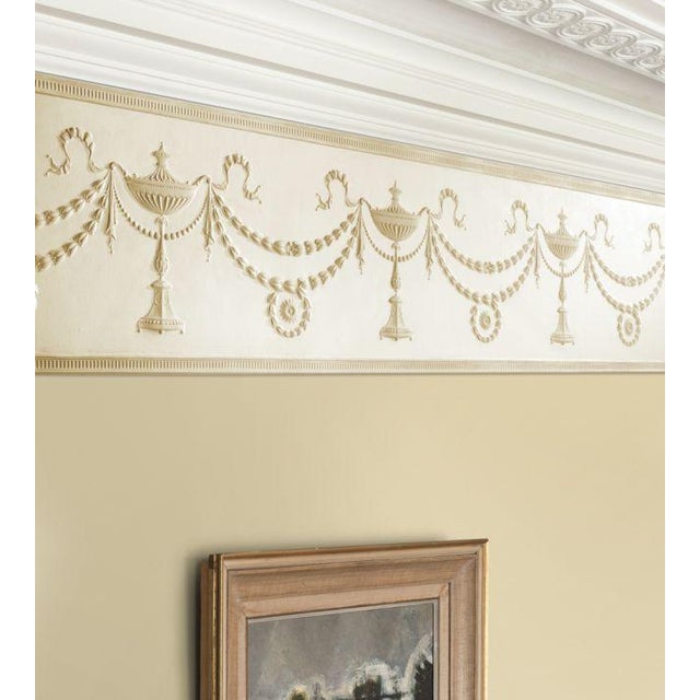 Adam's detailed Grecian urns are joined by garlands of leaves; creating a simple, pleasing, symmetrical design that looks...