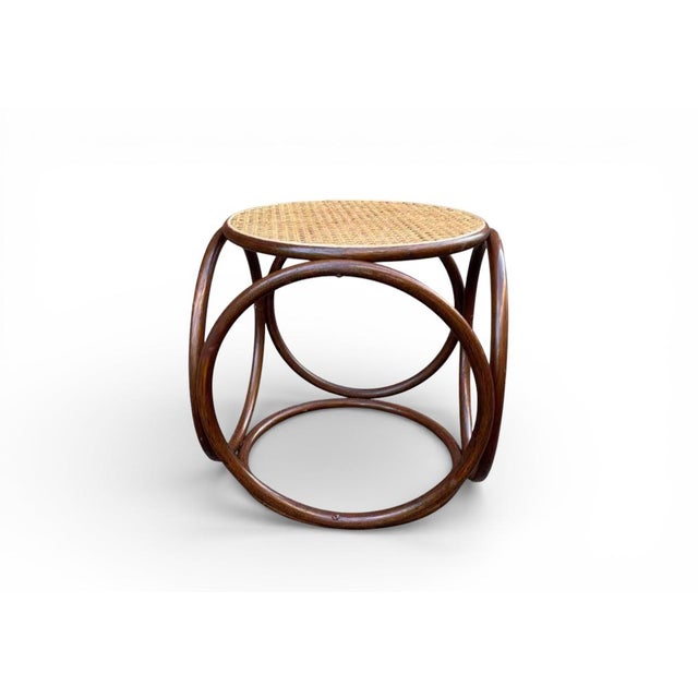 This Mid-Century Art Deco Thonet style woven rattan bentwood low stool / ottoman reflects the enduring influence of...