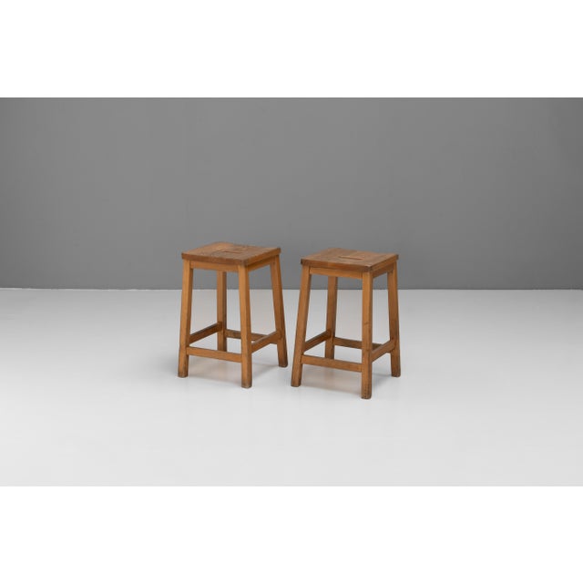 Pair of solid pine mid-century lab stools. Patina and signs of age. U.K circa 1950.