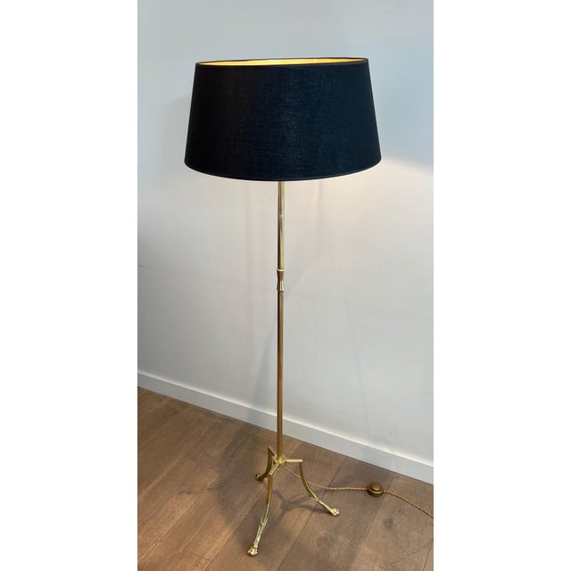 This beautiful and elegant neoclassical style tripod floor lamp is made of brass with claw feet. It is a French work by...