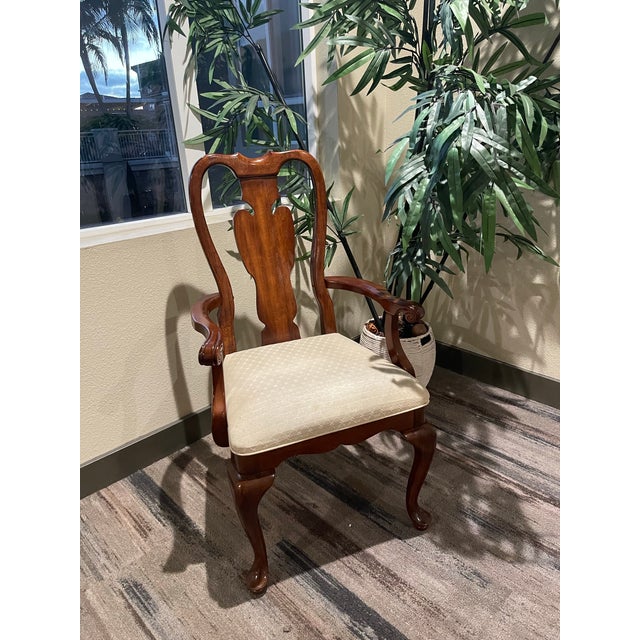 Graceful lines, rich mahogany tones, and timeless craftsmanship define this elegant armchair by Universal Furniture Ltd....