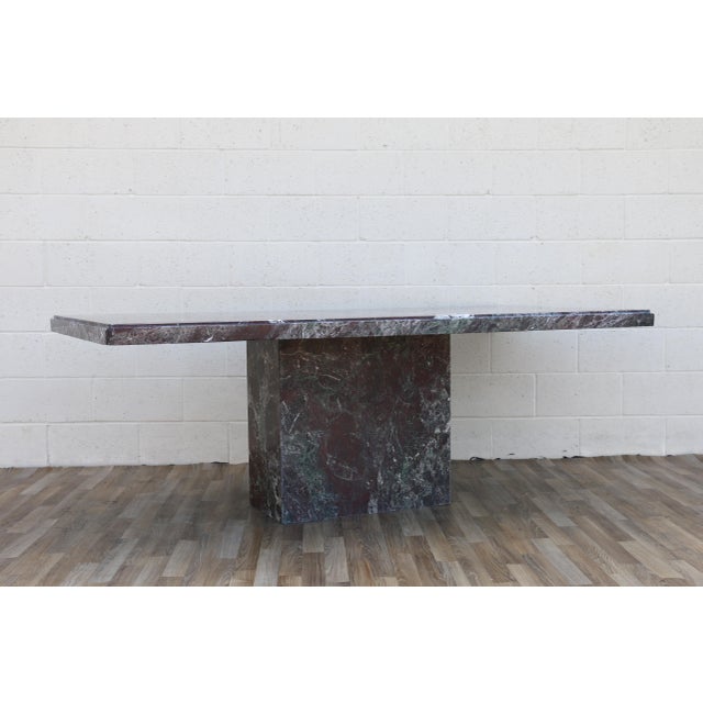 An exceptional 1970s Italian Postmodern dining table crafted entirely from richly veined Rosso Levanto marble. This...