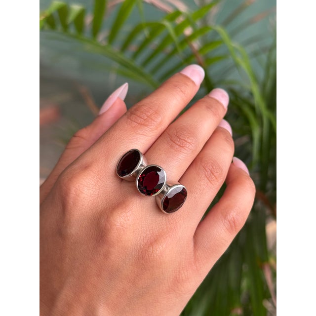 This 925 solid silver three stone garnet ring is designed for unisex appeal, featuring three oval-shaped garnets measuring...