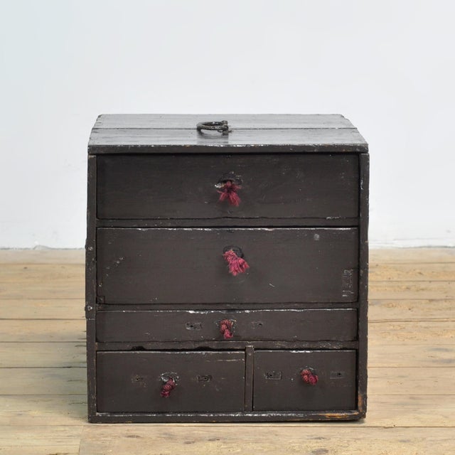This small Japanese chest of drawers from circa 1900 is a characterful and authentic piece of furniture that beautifully...