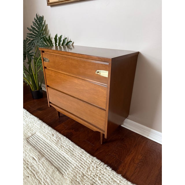 Gorgeous and unique (likely one of a kind) 3 drawer dresser with brass backplates and pulls. Features walnut wood and a...