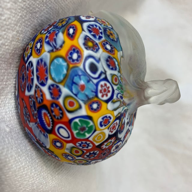 This is a colorful Murano Millefiori apple paperweight featuring multicolored glass mosaic murrini and a clear applied stem.