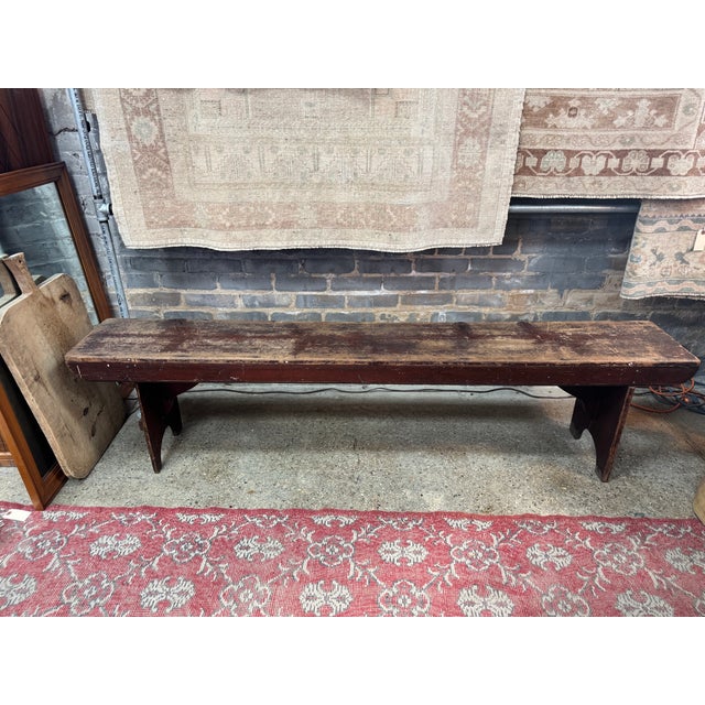 This primitive wood bench showcases the charm of early American country furniture. Featuring a long, single-board seat...