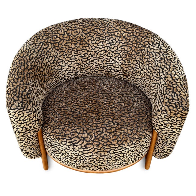 Modern stylish and bold barrel chair, featuring plush brown and black leopard-print polyester velvet upholstery paired...
