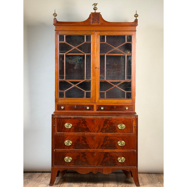 A handsome **Federal period flame mahogany secretary bookcase dating to circa 1810–1825**, combining impressive...