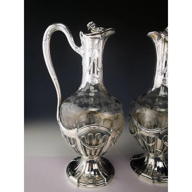 Superb pair of crystal ewers engraved with laurel branches Minerva silver (950) mounts, chased with garland decoration The...