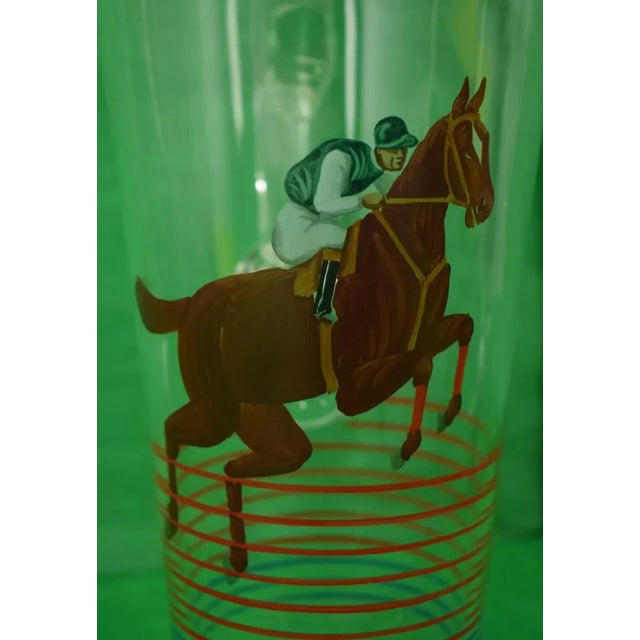 A unique pitcher with a hand painted equestrian motif. Prime for the race! Sz: 10 3/4"H x 8"L x 5"D rim