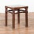 A Chinese Qing Dynasty period side table from the 19th century, with humpback stretchers and red undertone. Created in...