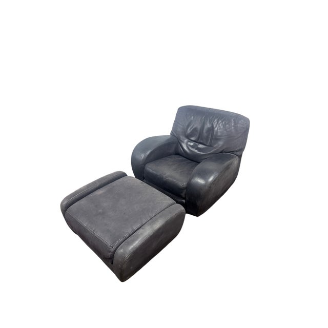 A black leather Roche Bobois lounge chair and ottoman. Comfort and luxury in one. Typical high quality leather from a...