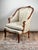 This antique French bergère arm chair is executed in the Louis XV Rococo style and dates to the mid-19th century. The...