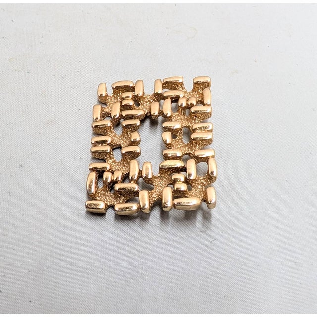 1971 Modernist goldtone rectangular cut out center smooth raised and textured lower sections brooch with security clasp....