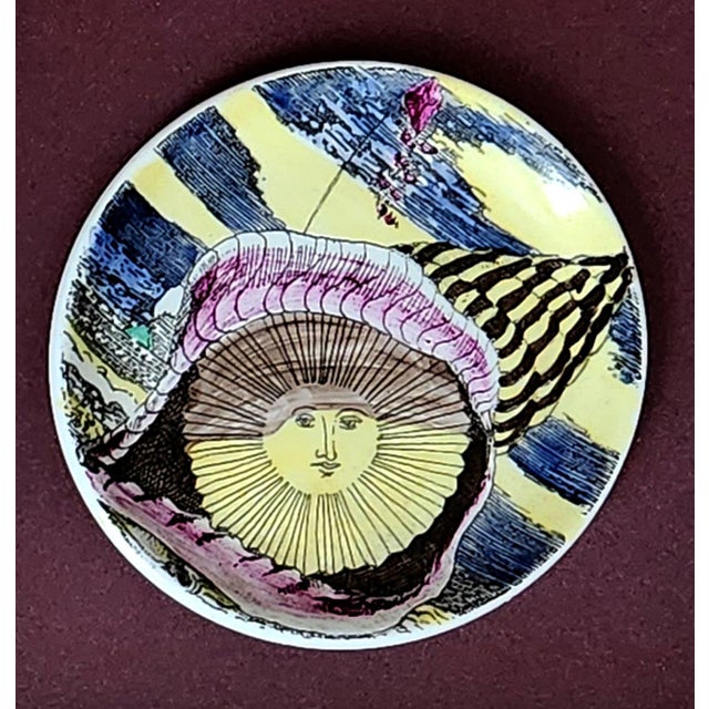 Piero Fornasetti “12 Mesi, 12 Soli” Porcelain Coaster, August, Sun in a Seashell, Framed Milan, circa 1960–1965 This...