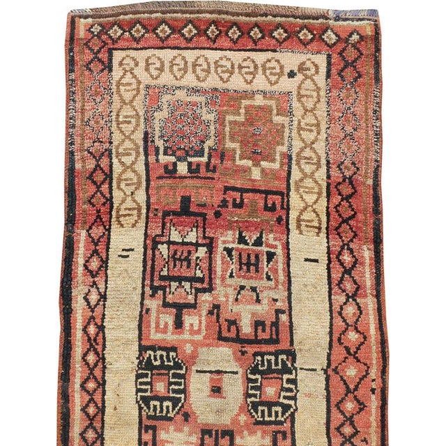 An antique Turkish Anatolian runner from the early 20th century. Anatolian, the rose-red field displays a geometric...