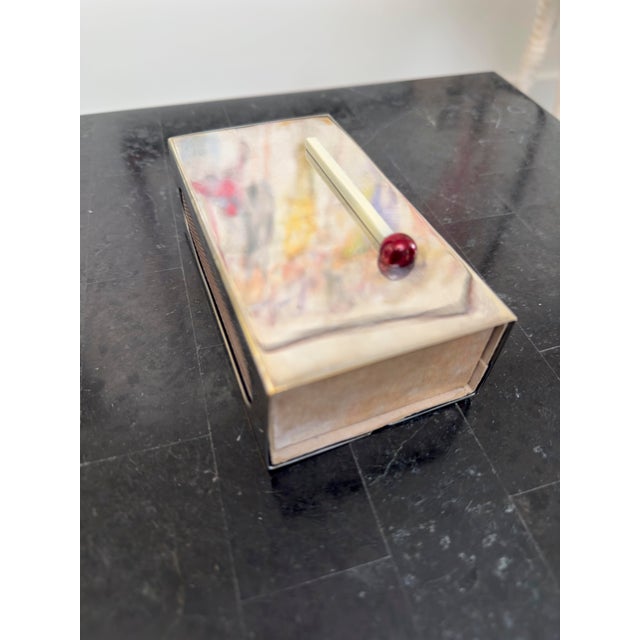 Unusual matchbook holder in silver plate with affixed articulable giant match and "SP" hallmark on reverse. Holds a large...