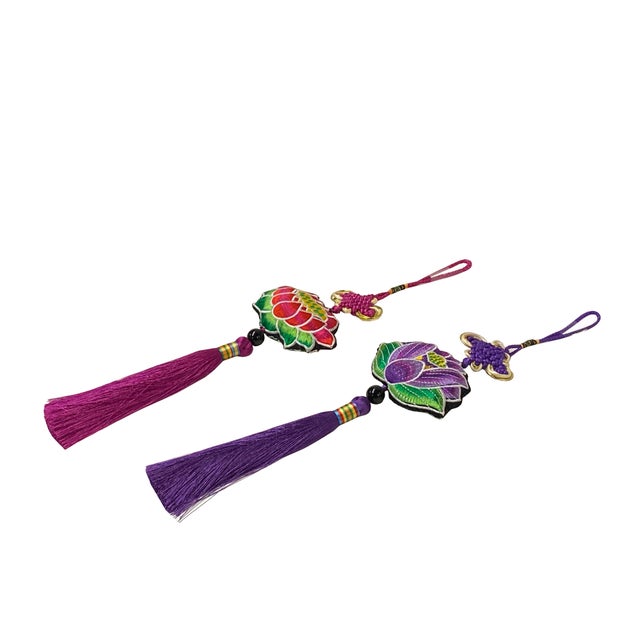 These ornate hanging ornaments feature a striking blend of traditional textile artistry and symbolic design. Each piece is...