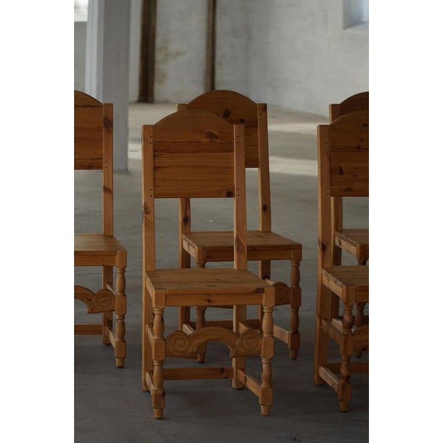 A charming set of eight Scandinavian dining chairs crafted in solid pine, dating from the 1950s. The chairs reflect the...