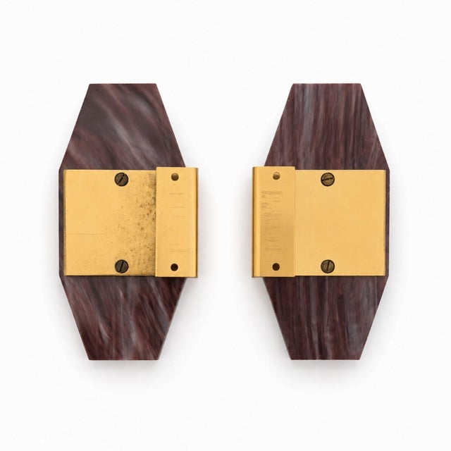 Decorative pair of Italian furniture handles from the 1970s, crafted in dark pink marbled resin with brass mounting...