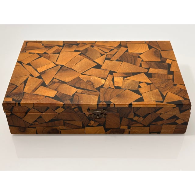A striking vintage olive wood box featuring an intricate mosaic surface composed of individually arranged wood pieces in...