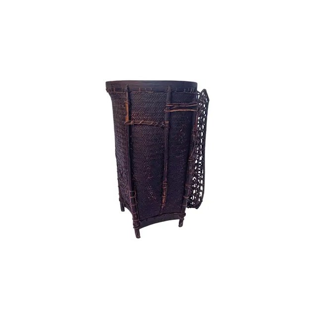 This vintage hand-woven basket originates from the Dayak tribe of Borneo crafted with rattan fibres and an ironwood frame...