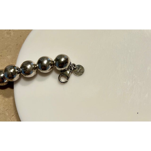 A Tiffany & Co. sterling silver ball bracelet, inspired by the 1962 archive design, 7" long, 6mm balls, engraved with...