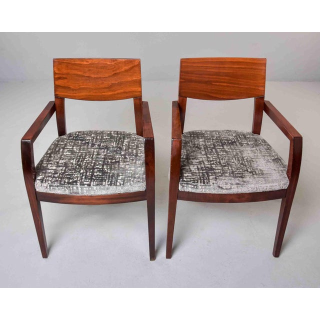 A refined pair of Art Deco style armchairs in figured mahogany, featuring beautifully grained back panels, angular open...